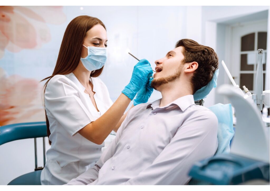 Dentist examining a patient while discussing bonding vs veneers cosmetic dentistry options