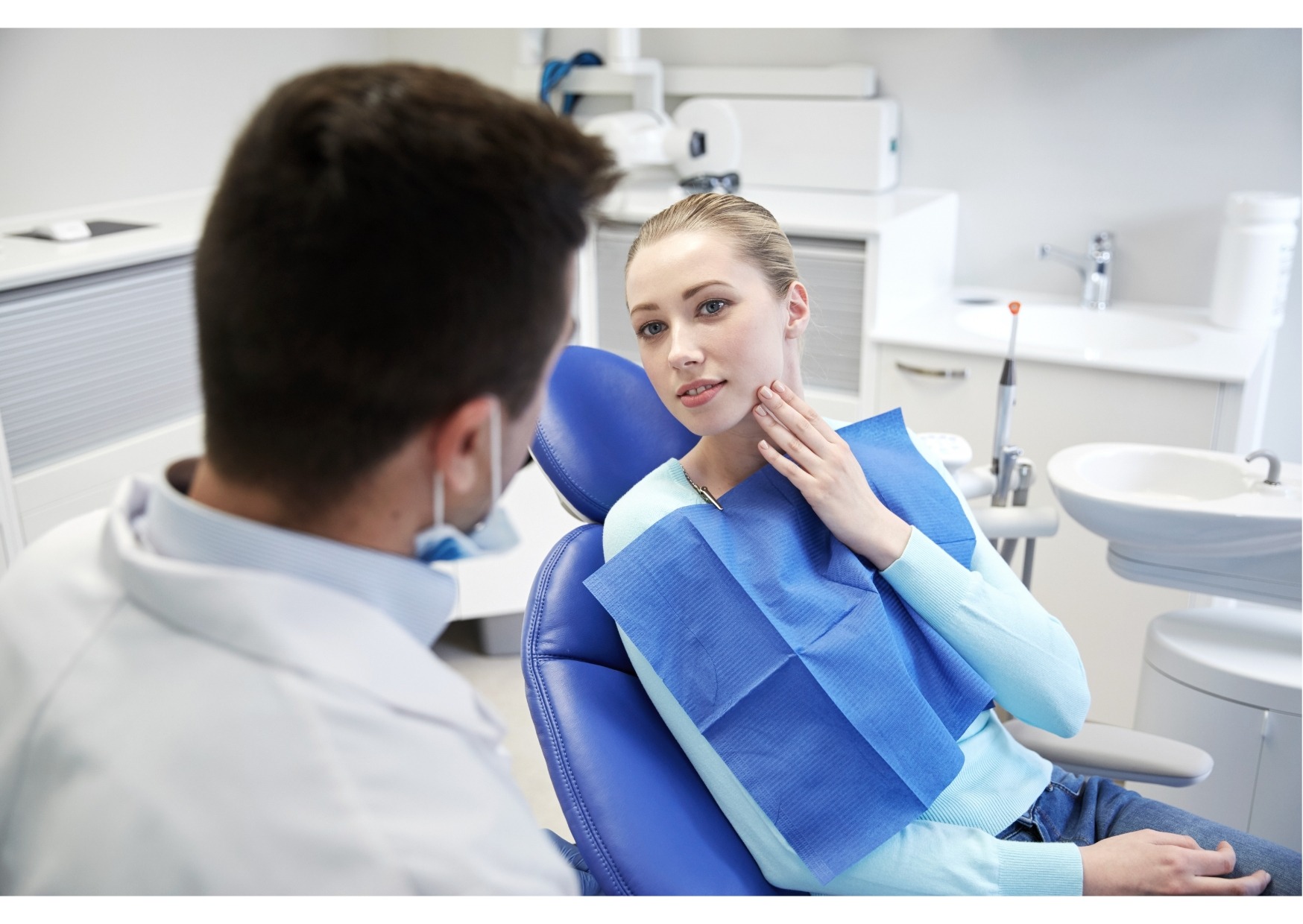 Patient discussing concerns with a dentist during a first dental appointment consultation
