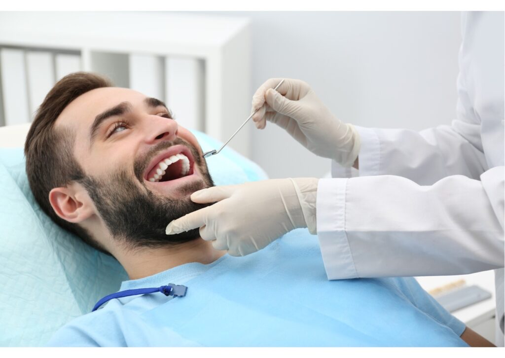 Dentist performing an oral exam during a patient’s first dental appointment and checkup