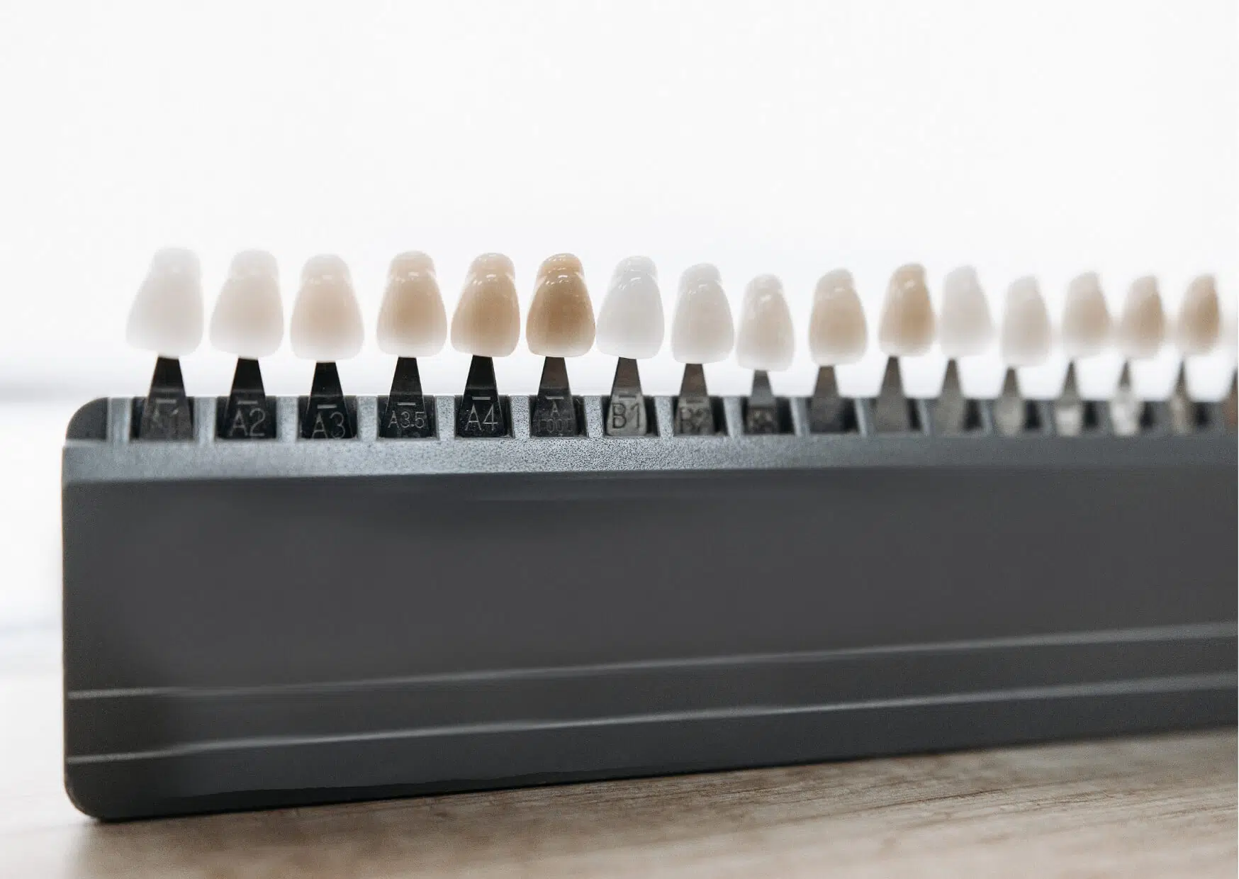 Dental shade guide displaying multiple veneer color options, commonly used during consultations to discuss veneers cost and cosmetic treatment goals.